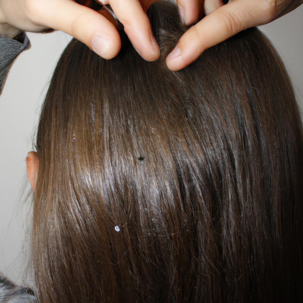 Person examining scalp for dandruff